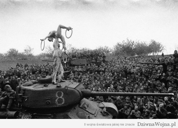 Soldiers Watch Acrobats Perform on Tank
